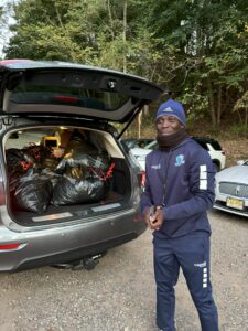 Coach Eddie picks up uniform and equipment donations